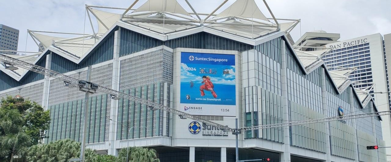 Large digital billboard on the facade of Suntec Singapore showcasing Crunchyroll’s 2024 F1 anime campaign – high-visibility DOOH placement in central business district