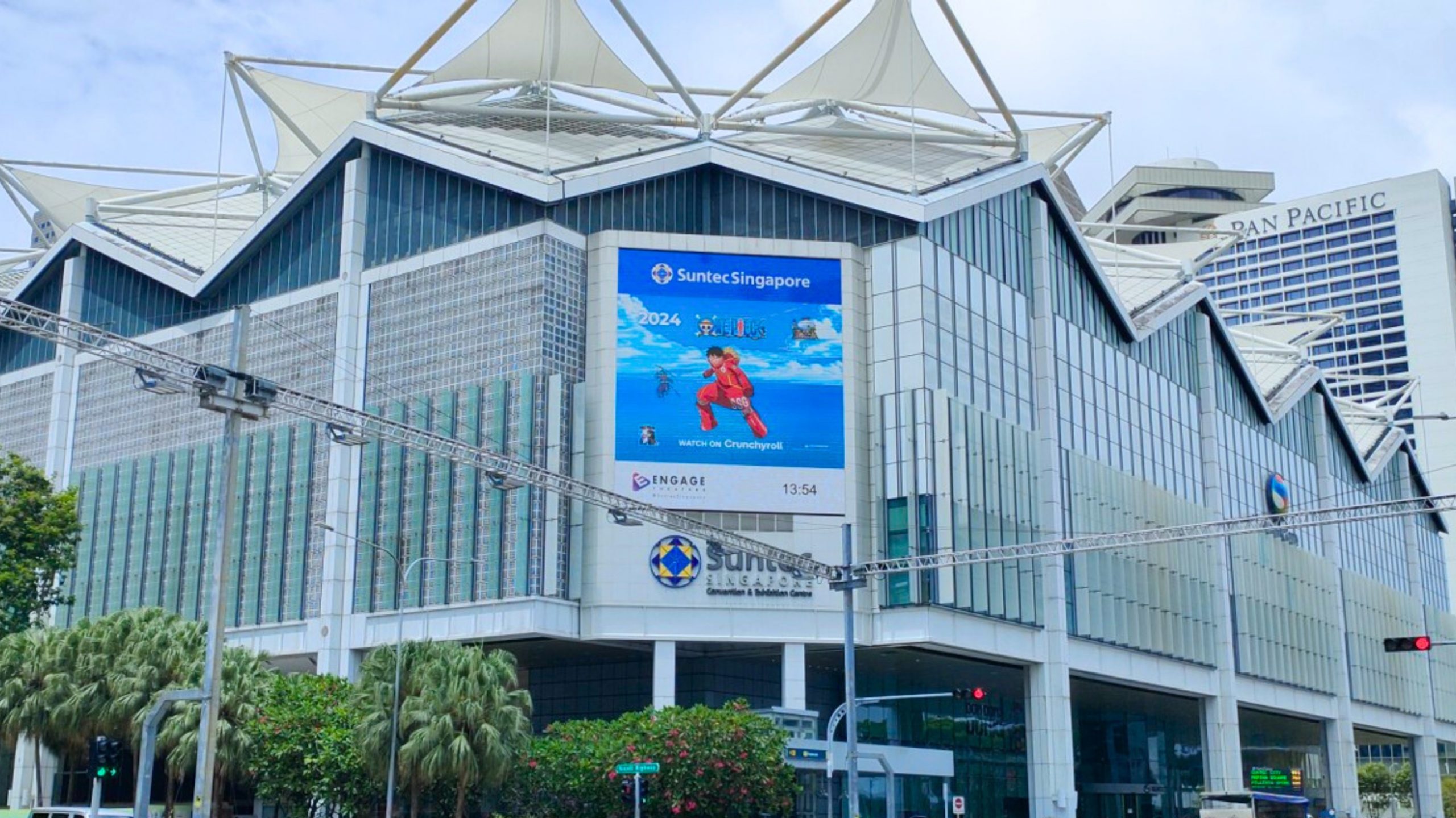Large digital billboard on the facade of Suntec Singapore showcasing Crunchyroll’s 2024 F1 anime campaign – high-visibility DOOH placement in central business district