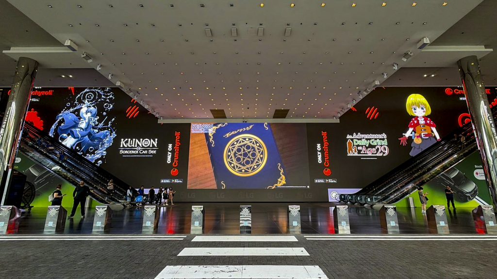 Crunchyroll anime campaign displayed on a massive large-format DOOH LED screen at Plaza Singapura, high-visibility indoor advertising environment in Singapore.