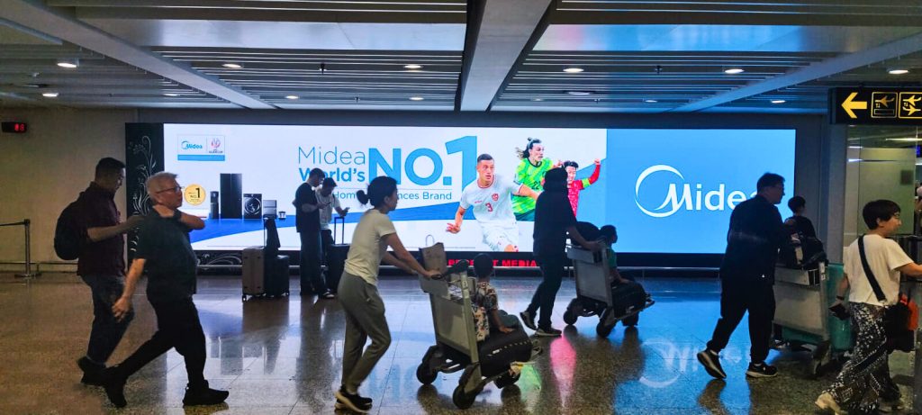 The perfect media Midea indoor LED airport advertising at Ngurah Rai International Airport Bali, delivering high-impact digital out-of-home exposure to international travelers