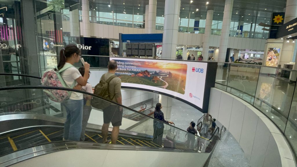 The perfect media UOB escalator digital billboard advertising at Kuala Lumpur International Airport, engaging international travelers through premium airport media in Malaysia.